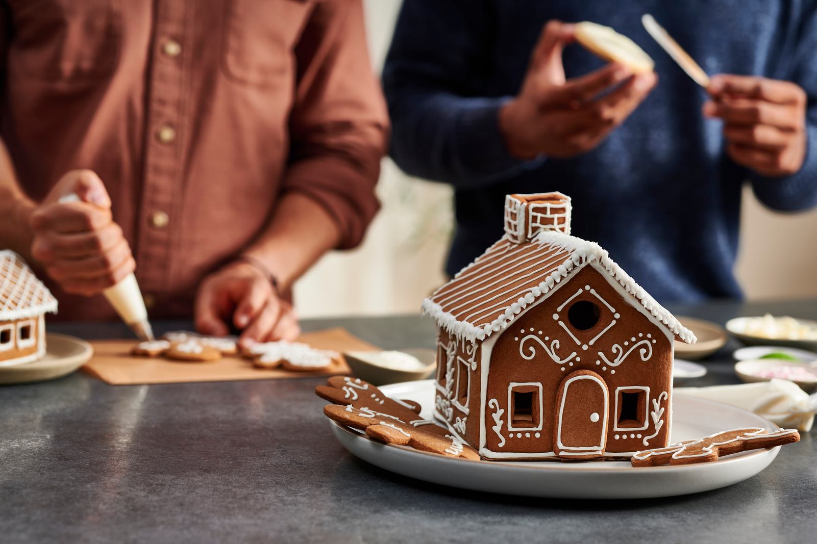 People building gingerbread house