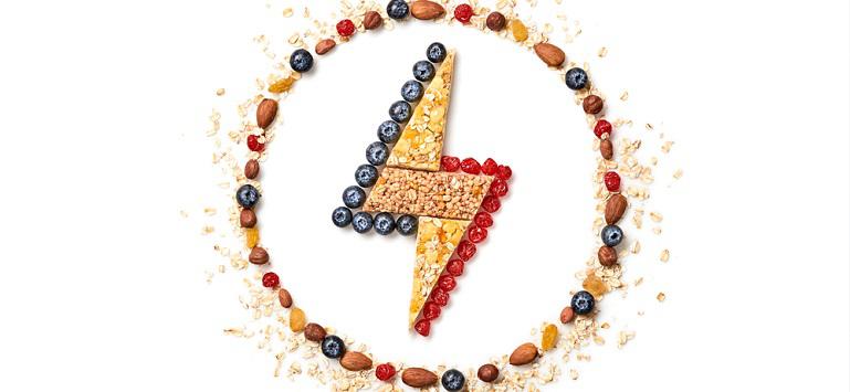 Energy power sign made of Granola bar encircled with nuts, dry fruit berries