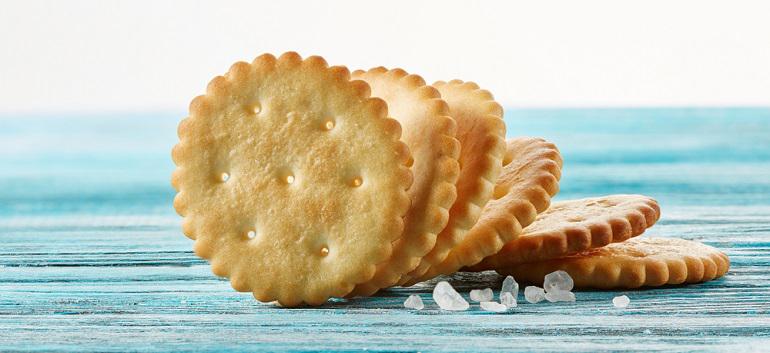 Dry thin crackers on a wooden table.