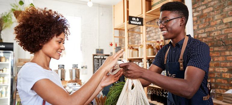 Customer Paying For Shopping At Checkout
