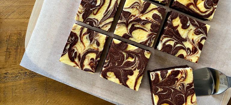 Chocolate cheese brownies squares on a board