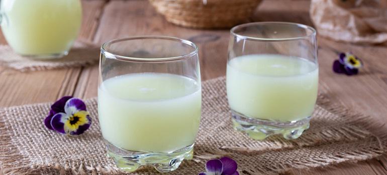 Fresh whey in two glasses and a jug